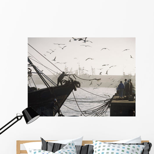 Man Throwing Rope To People On Dockside Of Harbor At Dusk Wall Mural