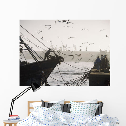 Man Throwing Rope To People On Dockside Of Harbor At Dusk Wall Mural