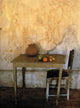 Table And Chairs Infront Of Weathered Wall Wall Mural