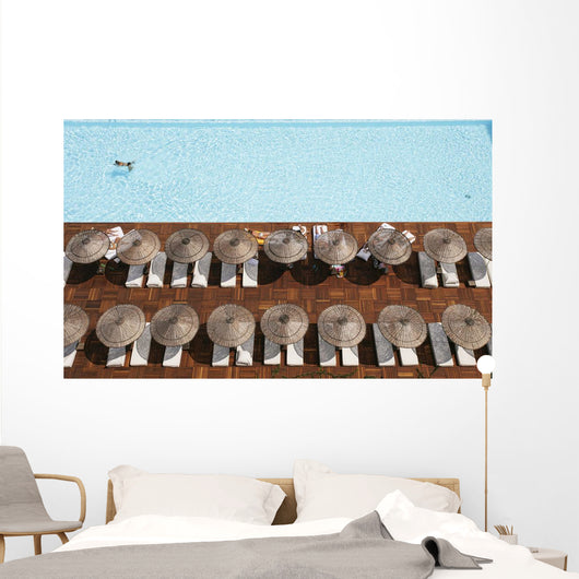Man Swimming In Pool By Sunloungers, Aerial View Wall Mural