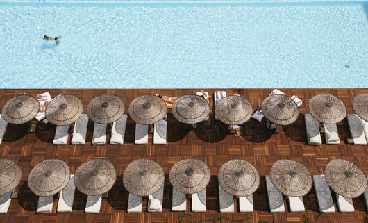 Man Swimming In Pool By Sunloungers, Aerial View Wall Mural