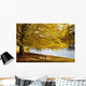 A Large Tree And Bench Along The Water In Autumn Wall Mural