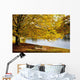 A Large Tree And Bench Along The Water In Autumn Wall Mural