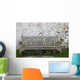 A Wooden Bench With Peeling Paint Against A White Wall Wall Mural