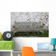 A Wooden Bench With Peeling Paint Against A White Wall Wall Mural