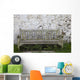A Wooden Bench With Peeling Paint Against A White Wall Wall Mural
