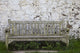 A Wooden Bench With Peeling Paint Against A White Wall Wall Mural