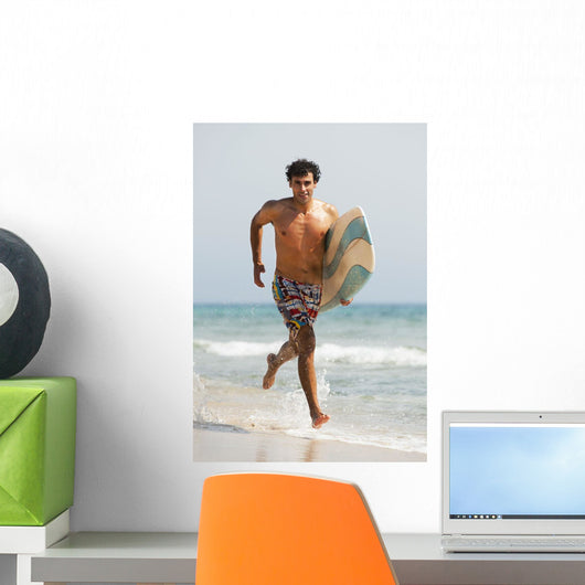 A Man Running Along Valdevaqueros Beach Carrying A Surf Board Wall Mural