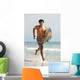 A Man Running Along Valdevaqueros Beach Carrying A Surf Board Wall Mural
