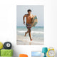 A Man Running Along Valdevaqueros Beach Carrying A Surf Board Wall Mural