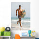 A Man Running Along Valdevaqueros Beach Carrying A Surf Board Wall Mural