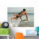 A Man Entering The Water On A Surf Board Off Valdevaqueros Beach Wall Mural