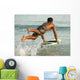 A Man Entering The Water On A Surf Board Off Valdevaqueros Beach Wall Mural