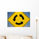 A Yellow Sign Showing Three Arrows Going In A Circle Wall Mural