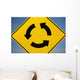 A Yellow Sign Showing Three Arrows Going In A Circle Wall Mural