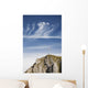 Mountain Peak With A Cross On Top Against A Blue Sky With Clouds Wall Mural
