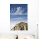 Mountain Peak With A Cross On Top Against A Blue Sky With Clouds Wall Mural