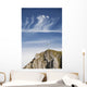 Mountain Peak With A Cross On Top Against A Blue Sky With Clouds Wall Mural