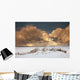 Illuminated Clouds Glowing Above A Snowy Field Wall Mural