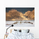 Illuminated Clouds Glowing Above A Snowy Field Wall Mural