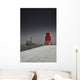 A Red Lighthouse Along The Coast In Winter With A Boat Off The Shore Wall Mural