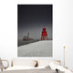 A Red Lighthouse Along The Coast In Winter With A Boat Off The Shore Wall Mural