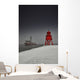 A Red Lighthouse Along The Coast In Winter With A Boat Off The Shore Wall Mural