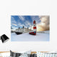 Boats Sitting On A Frozen Surface With A Lighthouse And Building Wall Mural