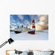 Boats Sitting On A Frozen Surface With A Lighthouse And Building Wall Mural