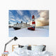 Boats Sitting On A Frozen Surface With A Lighthouse And Building Wall Mural