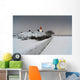 A Snow Covered Fence With A Lighthouse And Building In The Background Wall Mural