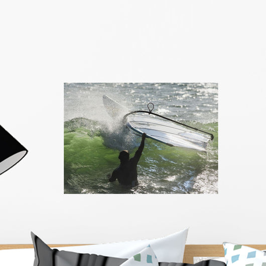 A Man In The Water Holding Onto His Windsurfing Board Wall Mural
