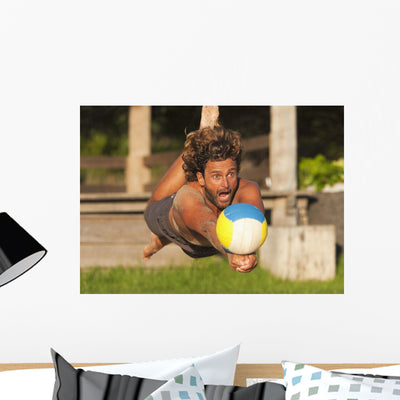 Man Diving for Beach Wall Mural shown on a wall