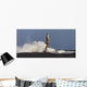 Waves Crashing Against A Lighthouse Wall Mural