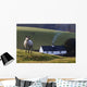 A Sheep Standing On A Hill With A House In The Background Wall Mural