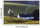 A Sheep Standing On A Hill With A House In The Background Wall Mural