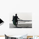 A Man Walking On The Beach Carrying A Kite Surfboard Wall Mural