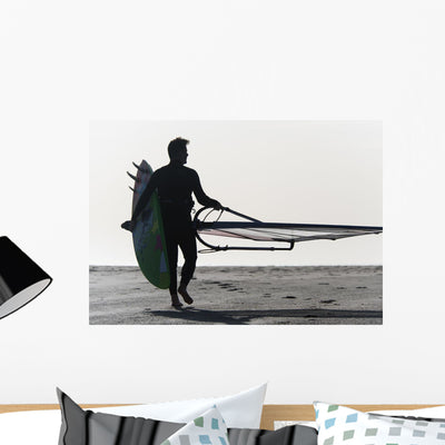 Man Walking Beach Carrying Wall Mural shown on a wall