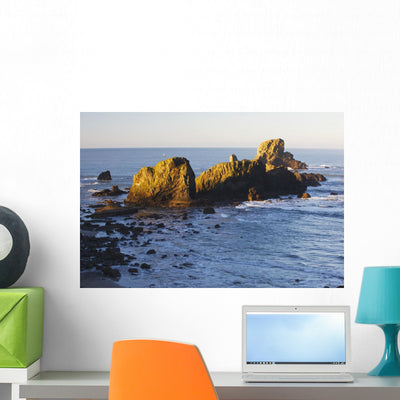 Sun Shining Rocks Sunrise Wall Mural shown on a wall
