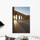 A row of archways against a blue sky and sunlight shining through Wall Mural