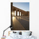 A row of archways against a blue sky and sunlight shining through Wall Mural