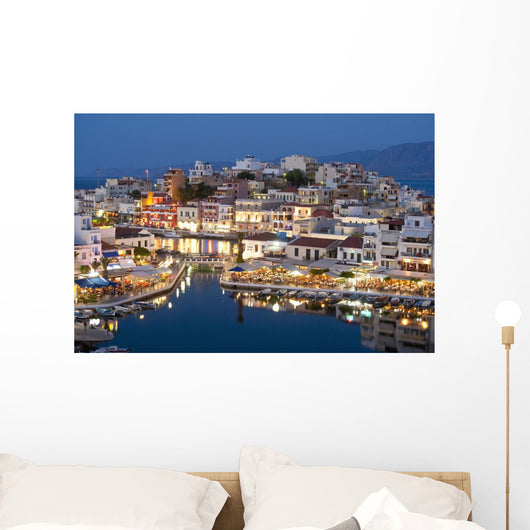 Greece, Crete, View of Lake Vouismeni and town at dusk Wall Mural