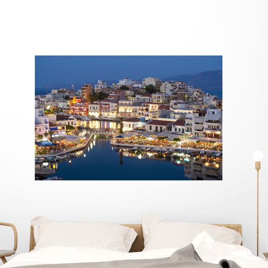 Greece, Crete, View of Lake Vouismeni and town at dusk Wall Mural