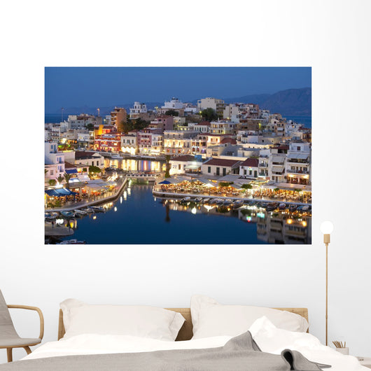 Greece, Crete, View of Lake Vouismeni and town at dusk Wall Mural
