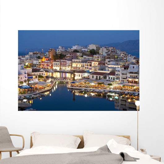 Greece, Crete, View of Lake Vouismeni and town at dusk Wall Mural