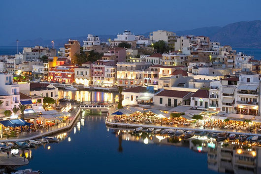 Greece, Crete, View of Lake Vouismeni and town at dusk Wall Mural