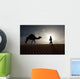 Silhouette Of Berber Leading Camel Across Sand Dunes At Dusk Wall Mural