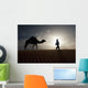 Silhouette Of Berber Leading Camel Across Sand Dunes At Dusk Wall Mural