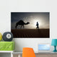Silhouette Of Berber Leading Camel Across Sand Dunes At Dusk Wall Mural