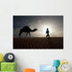 Silhouette Of Berber Leading Camel Across Sand Dunes At Dusk Wall Mural